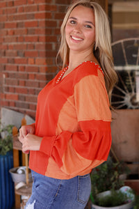 Fiery Red Studded V Neckline Exposed Seam Textured Knit Top